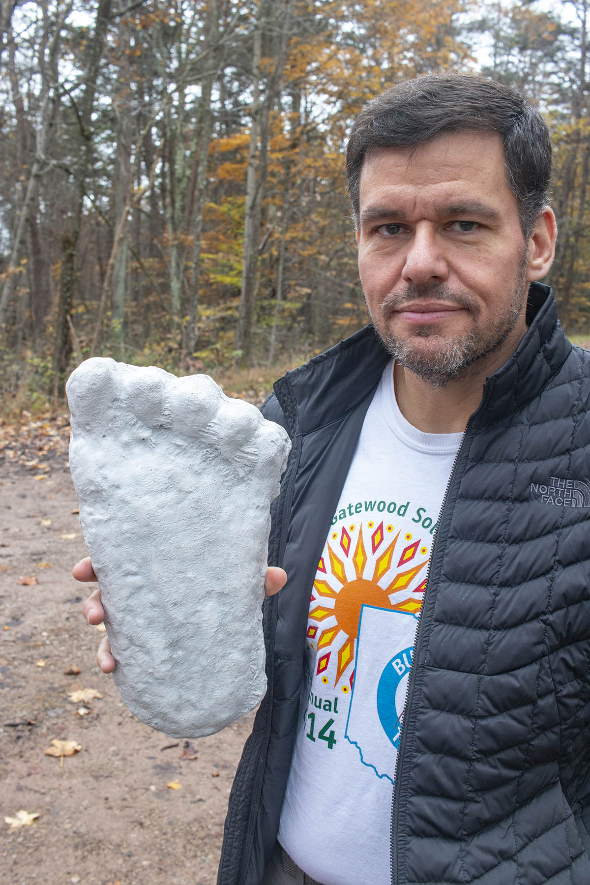 Photo of Marc Dewerth with a replica of a plaster cast of a Sasquatch footprint